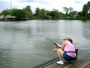 Lady fighting large Mekong at Bungsam Lan.