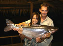 Lady with a Striped Catfish at night.